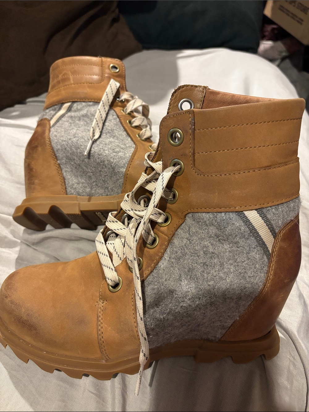 Sorel shown of Arctic Wedge III Lexie Tan and Gray Lace-Up Wedge Boots